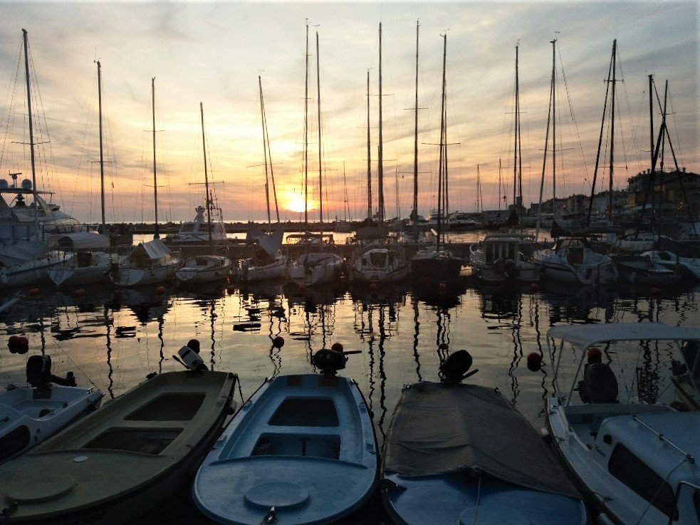 sunset over Piran by the harbour