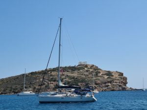 Temple of Poseidon, Sunion Greece with a yacht in the foreground
