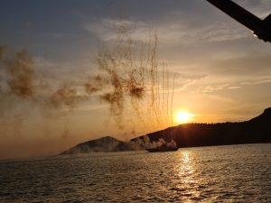 Fireworks from a boat, at sunset, anchored of Sunion, Greece