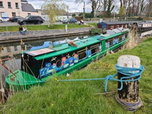 Colourful green canal boat tied up on the grand canal in Sallins Co Kildare