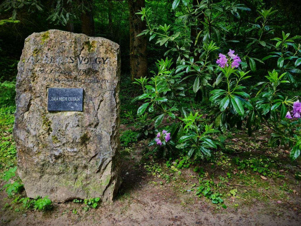 Standing stone at the entrance to Azáleás völgy - Azalea Valley - with an inscription in Hungarian making it was one of the seven wonders of Zala, a county in Western Hungary. 