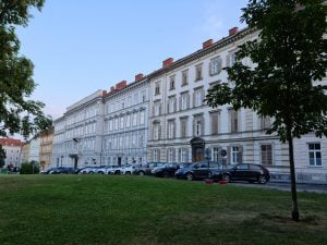 row of four-story terraced houses overlooking Stadrpark in Graz
