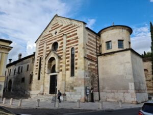 Church with white marble front and round tower to the right with two windows peeking above a high wall