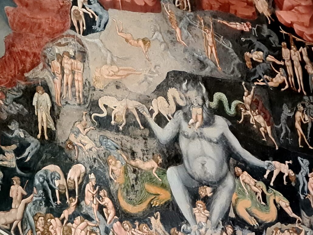 A vivid fresco of hell - red on black. Lots of naked bodies in anguish. The devil looks black with horns swinging naked bodies from each hand. 