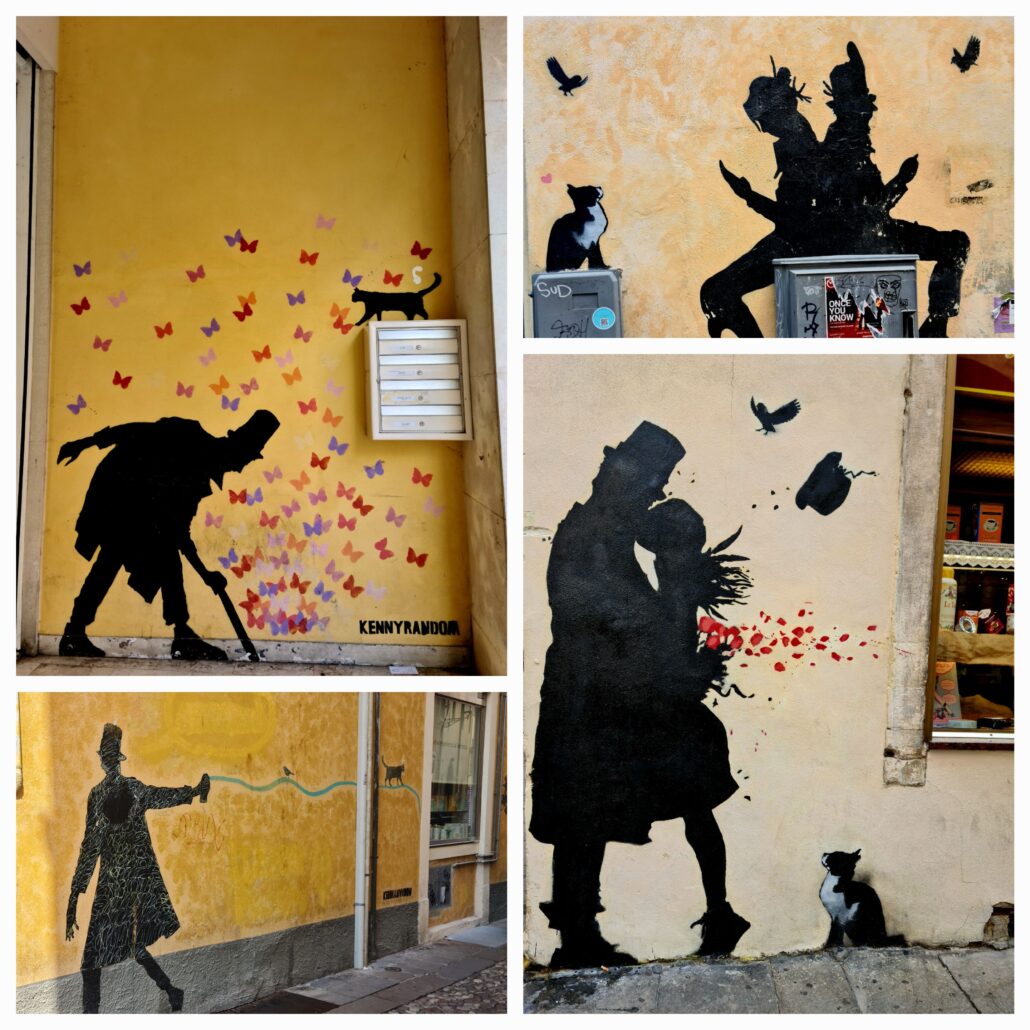 A collage of four photos of grafitti. 1. The silhouette of a hunched man in a black hat walking with lots of butterflies on the wall and a black cat on top of a post box. 2. A black cat sits on a box wathcing a bird fly overhead. A couple sit back to back, she's reading. He's watching another bird fly overhead. Titled "The Sense of Wonder," it shows silhouettes of a man and a woman kissing. She stands on tiptoes to reach him. His hands, around her back, hold a bouquet of red flowers, petals flying off in the wind. A silhouette bird hovers overhead and the woman's hat blows away. A black and white cat sits nearby, watching. 4. A black silhouette of a man in a hat walking trailing a green ribbon behind hime on which a bird sits and a cat walks. 