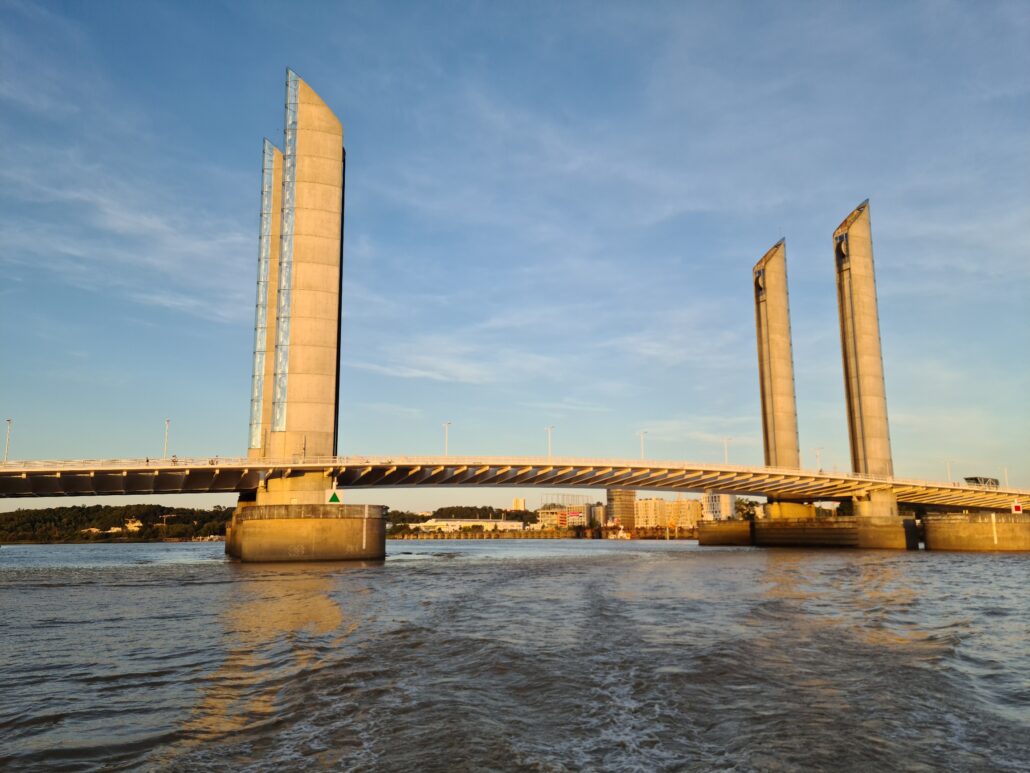 Tall lift bridge with four columns spanning the Garonne River in Bordeaux