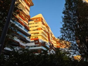 Sunlight bathing an apartment building in bright yellow