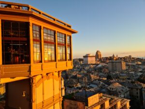 Sun hittting a wooden tower on the left overlooking a city below