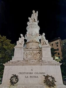Statue of Christopher Columbus set against a black night sky