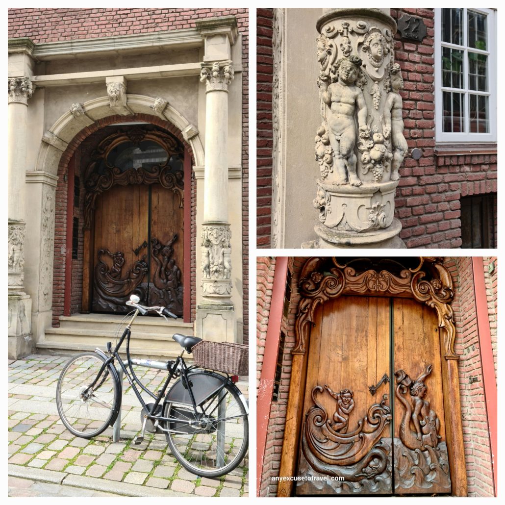 A collage of three photos. 1. A double wooden door set in an white stone archway with two steps leading up to it. The pavement is made of coloured brick./ A black bicycle with a basket on the carried leans against a stone pillar. 2. a close up of the stone pillar with angel reliefs. 3. a close up of the wooden door with what appears to be carvings of men in boats. 