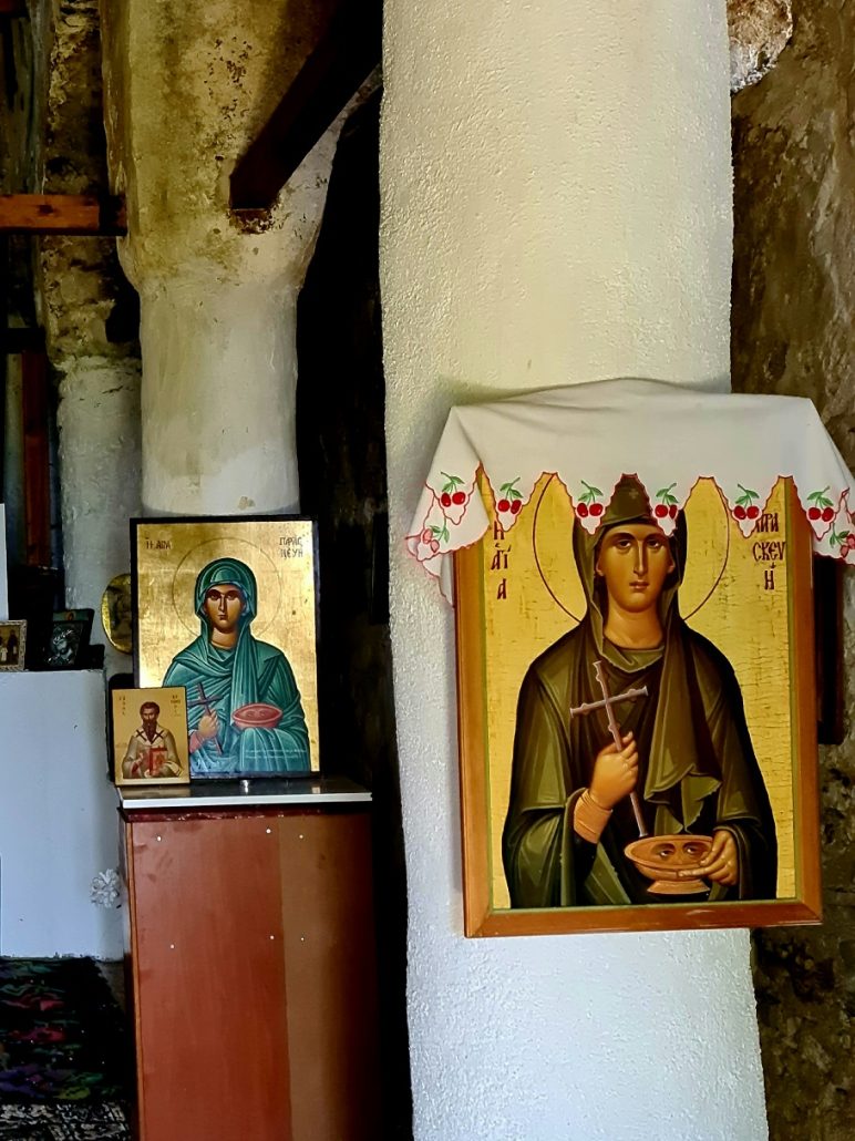 two Russian icons on - both of a female holding a cross and a bowl with eyes on it