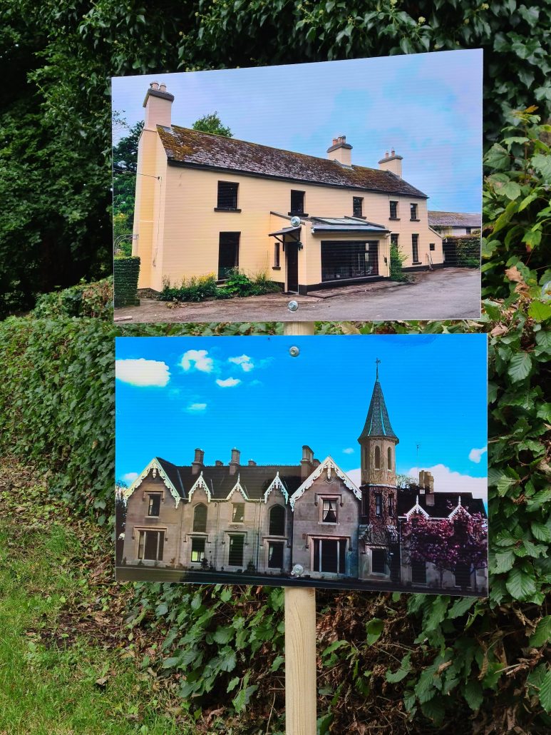 Two blown-up photos nailed to a wooded stake in front of a green hedge. The top one shows a two-storey farmhouse with three chimneys and a slate roof. Five windows on the first floor and three on the bottom with a porch entry. Painted yellow. Below a manor house from the 1800s complete with spired tower and 8 chimneys. Grey stone. 