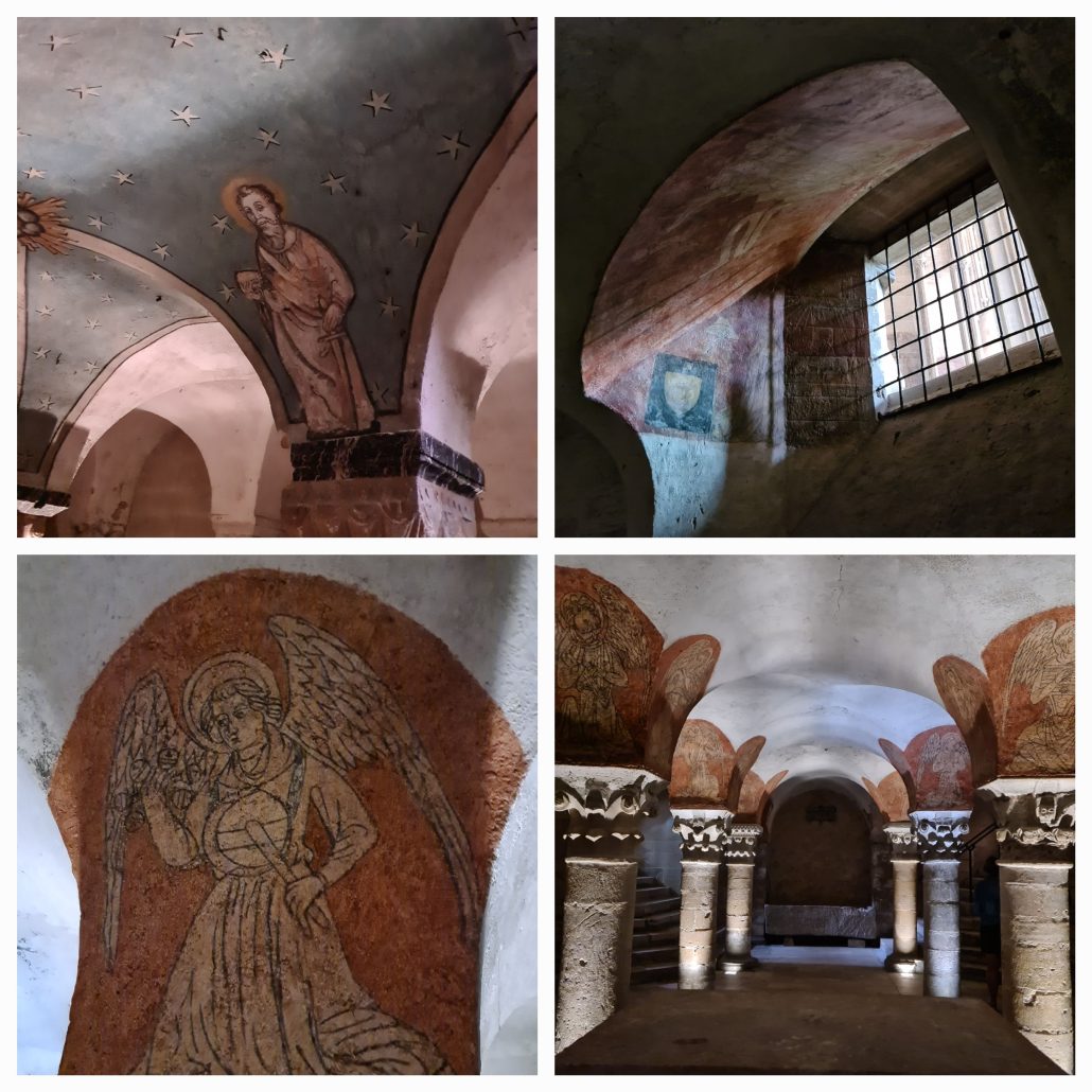 four photos of crypt (1) fresco of a bearded robed man with a halo against a blue background with gold stars 2) gridded window letting in light that highlights old frescos 3) crypt with three pillars either side, an arched roof with the tops of the pillars bearing red and gold frescos 4) a close-up of a fresco of a golden winged angel against a red background