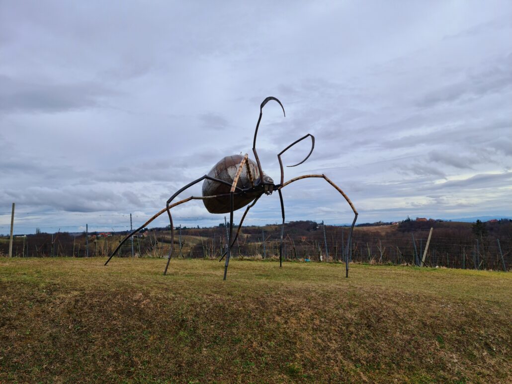 Large iron sculpture in a field - looks like an large ant
