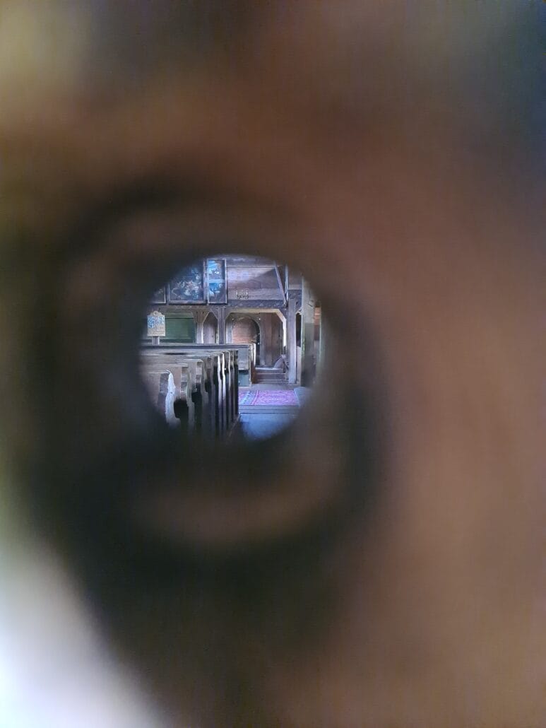 Church interior seen through a keyhole - wooden pews - oil paintings