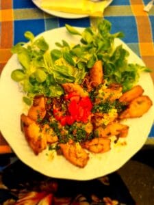 A plate of grilled calamari with salad greens