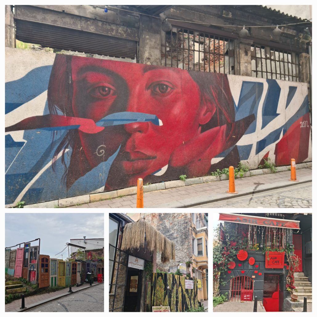 Colourful street murals, a fence made of brightly painted doors, a black building w3ith bright red decorations