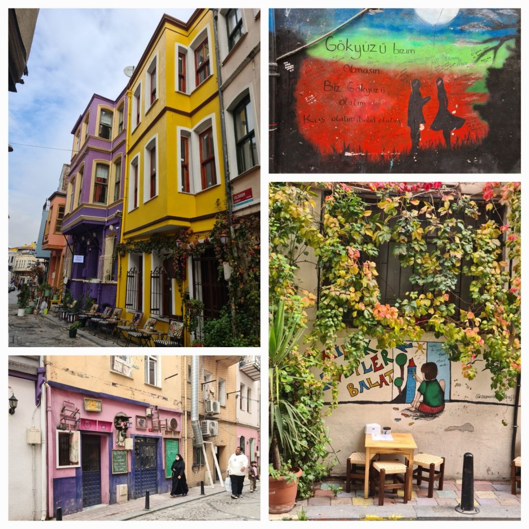 Yellow, purple, and orange three-story terraced buildings; a mural of the silhouettes of a boy and girl on red; hanging flowers partly cover a mural of a boy painting with the words "Biler Balat" visible; a woman in a burka walking past a purple and pink cafe.