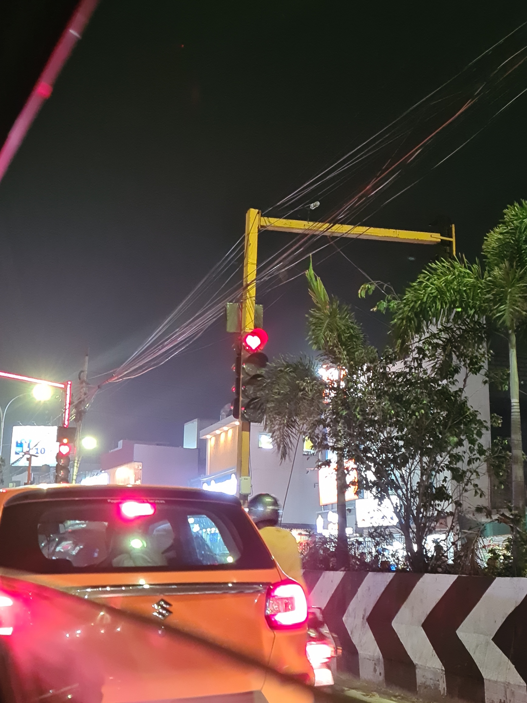 Red traffic light showing a red heart rather than a circle