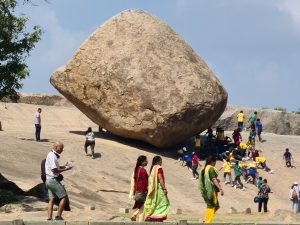 The boulder is approximately six metres (20 ft) high and five metres (16 ft) wide and weighs around 250 tonnes (250 long tons; 280 short tons).[14] It seems to float and barely stand on a slope on top of a 1.2-meter (4 ft) high plinth which is a naturally eroded hill. The rock is estimated to be 1,200 years old